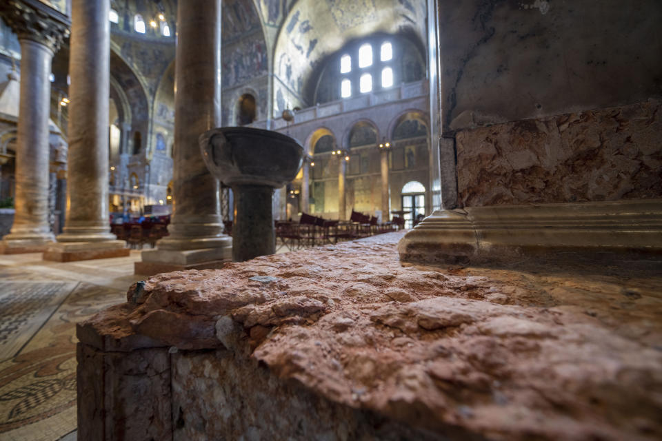 Signs of erosion are visible inside St. Mark's Basilica in Venice, northern Italy, Wednesday, Dec. 7, 2022. Glass barriers that prevent seawater from flooding the 900-year-old Venice's iconic Basilica during high tides have been recently installed. St. Mark's Square is the lowest-laying city area and frequently ends up underwater during extreme weather. (AP Photo/Domenico Stinellis)