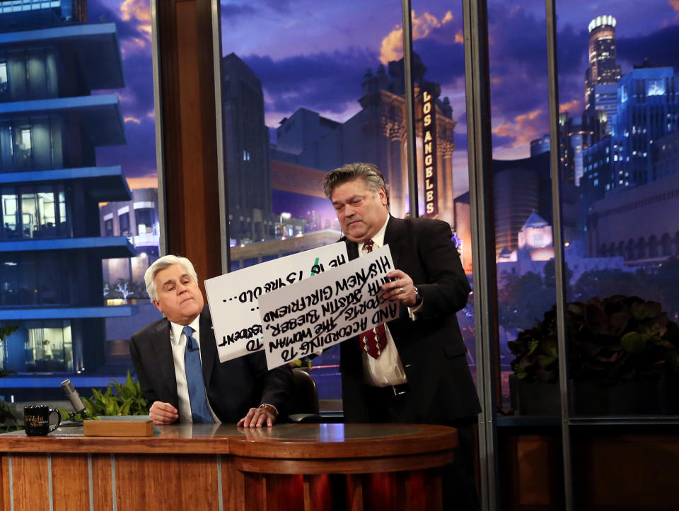 Jay Leno, left, looks at cue cards during the final taping of NBC's “The Tonight Show with Jay Leno," in Burbank, Calif., Thursday, Feb. 6, 2014. Leno brings his 22-year career as the show host to an end Thursday in a special one-hour farewell broadcast. (Photo by Matt Sayles/Invision/AP)