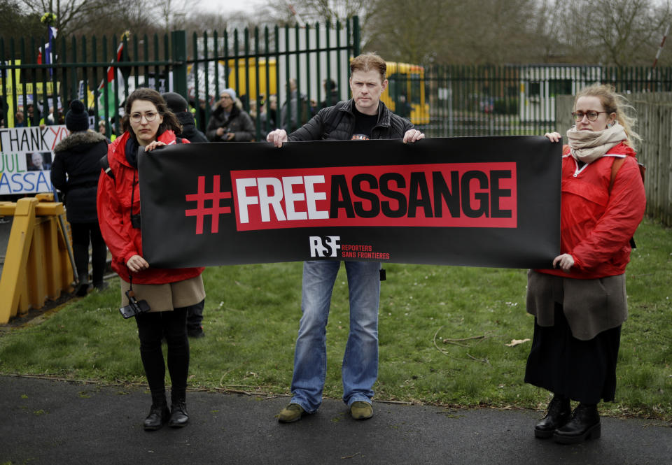 Supporters hold a banner which reads 'Free Assange' as they protest against the extradition of Wikileaks founder Julian Assange outside Belmarsh Magistrates Court in London, Monday, Feb. 24, 2020. The U.S. government and WikiLeaks founder Julian Assange will face off Monday in a high-security London courthouse, a decade after WikiLeaks infuriated American officials by publishing a trove of classified military documents. (AP Photo/Matt Dunham)