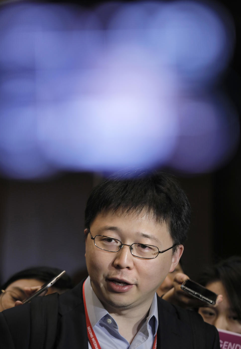 Feng Zhang, center, an institute member of Harvard and MIT's Broad Institute, speaks to reporters on the issue of world's first genetically edited babies after the Human Genome Editing Conference in Hong Kong, Tuesday, Nov. 27, 2018. He Jiankui, a Chinese researcher, claims that he helped make the world's first genetically edited babies twin girls whose DNA he said he altered with a powerful new tool capable of rewriting the very blueprint of life. If true, it would be a profound leap of science and ethics. (AP Photo/Vincent Yu)