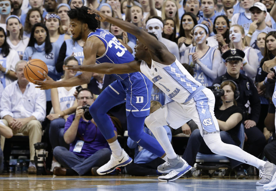 North Carolina’s Theo Pinson chases the ball with Duke’s Marvin Bagley III (35) during the second half of an NCAA college basketball game in Chapel Hill, N.C., Thursday, Feb. 8, 2018. North Carolina won 82-78. (AP Photo/Gerry Broome)