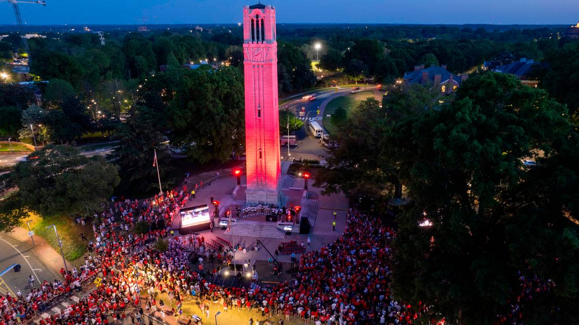 NC State’s Memorial Belltower is bathed in red light as more than a thousand fans celebrate the men’s and women’s basketball teams’ Final Four runs on Monday, April 15, 2024.