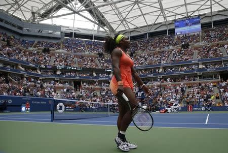 Serena Williams of the U.S. walks on the court as she plays Roberta Vinci of Italy during their women's singles semi-final match at the U.S. Open Championships tennis tournament in New York, September 11, 2015. REUTERS/Shannon Stapleton -