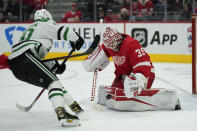 Detroit Red Wings goaltender Alex Nedeljkovic (39) stops a Dallas Stars center Jacob Peterson (40) shot in the third period of an NHL hockey game Friday, Jan. 21, 2022, in Detroit. (AP Photo/Paul Sancya)