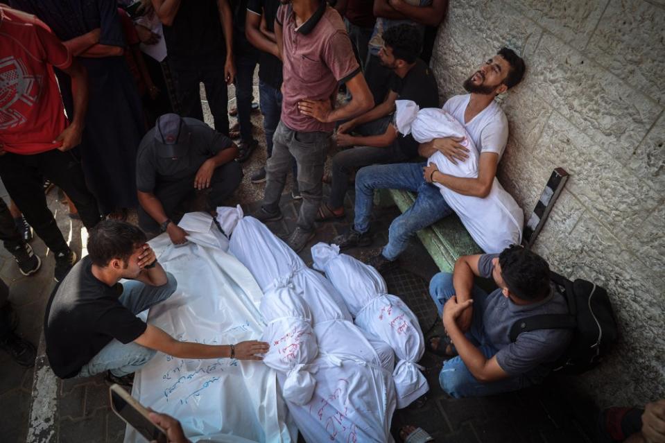 People say goodbye to their relatives after the Abu Rakab family home was bombed on July 18, 2024.