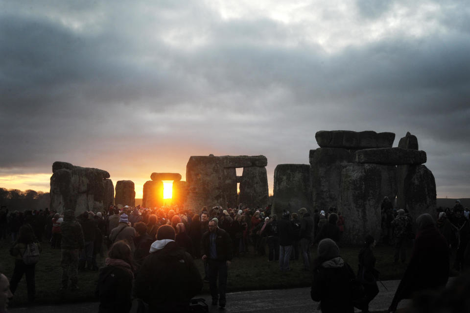 People watch the sunrise at the winter solstice celebration at Stonehenge in Wiltshire, England, in this photo from Dec. 22, 2011. / Credit: Tim Ireland/PA Images via Getty Images