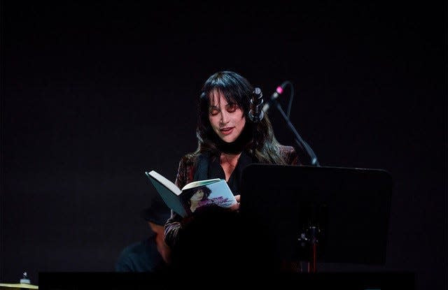 Holly Knight reading from "I Am the Warrior" at book event.