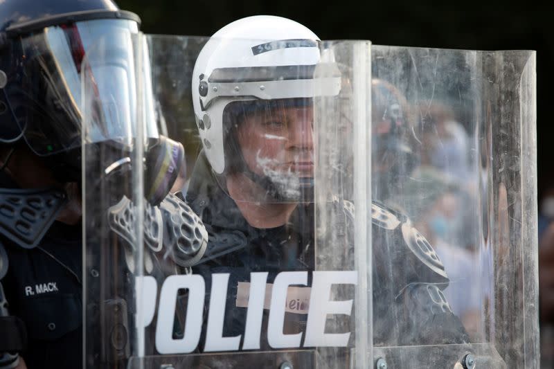 A policeman watches through his riot shield during a protest against the death in Minneapolis of African-American man George Floyd, in Atlanta, Georgia