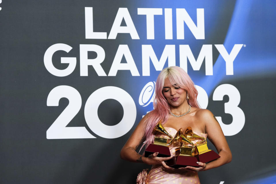 Karol G poses with the awards for best urban album for "Mañana Sera Bonito", for album of the year for "Mañana Sera Bonito" and the award for best urban fusion/performance for "TQG" during the 24th annual Latin Grammy Awards in Seville, Spain, Thursday, Nov. 16, 2023. (Photo by Jose Breton/Invision/AP)