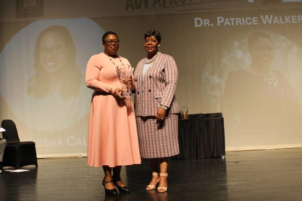 Honoree Dr. Patrice Walker, left, receives the Ruth Hartley Mosley Pioneer of Community Advancement award at the inaugural Central Georgia Women of Impact Awards.