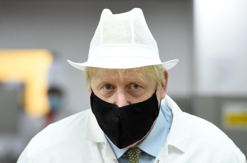 Britain's Prime Minister Boris Johnson, wearing a face mask or covering due to the COVID-19 pandemic, reacts during his visit to Royal Berkshire NHS Hospital in Reading, west of London on October 26, 2020, to mark the publication of a new review into hospital food. (Photo by Jeremy Selwyn / POOL / AFP) (Photo by JEREMY SELWYN/POOL/AFP via Getty Images)
