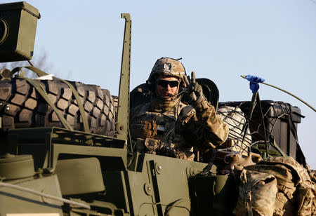 A soldier from convoy of U.S. troops, a part of NATO's reinforcement of its eastern flank, who are on their way from Germany to Orzysz in northeast Poland, drives through Sulejowek towards a military base in Wesola, near Warsaw, Poland, March 28, 2017. REUTERS/Kacper Pempel