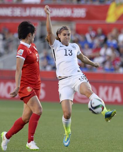 United States&#39;Alex Morgan (13) controls the ball as China&#39;s Li Dongna (6) defends during the first half quarterfinal match in the FIFA Women&#39;s World Cup soccer tournament, Friday, June 26, 2015, in Ottawa, Ontario, Canada. (Adrian Wyld/The Canadian Press via AP)