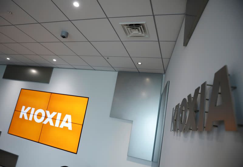 Japanese chipmaker Kioxia's logo and promotional video on a screen are pictured at its headquarters in Tokyo
