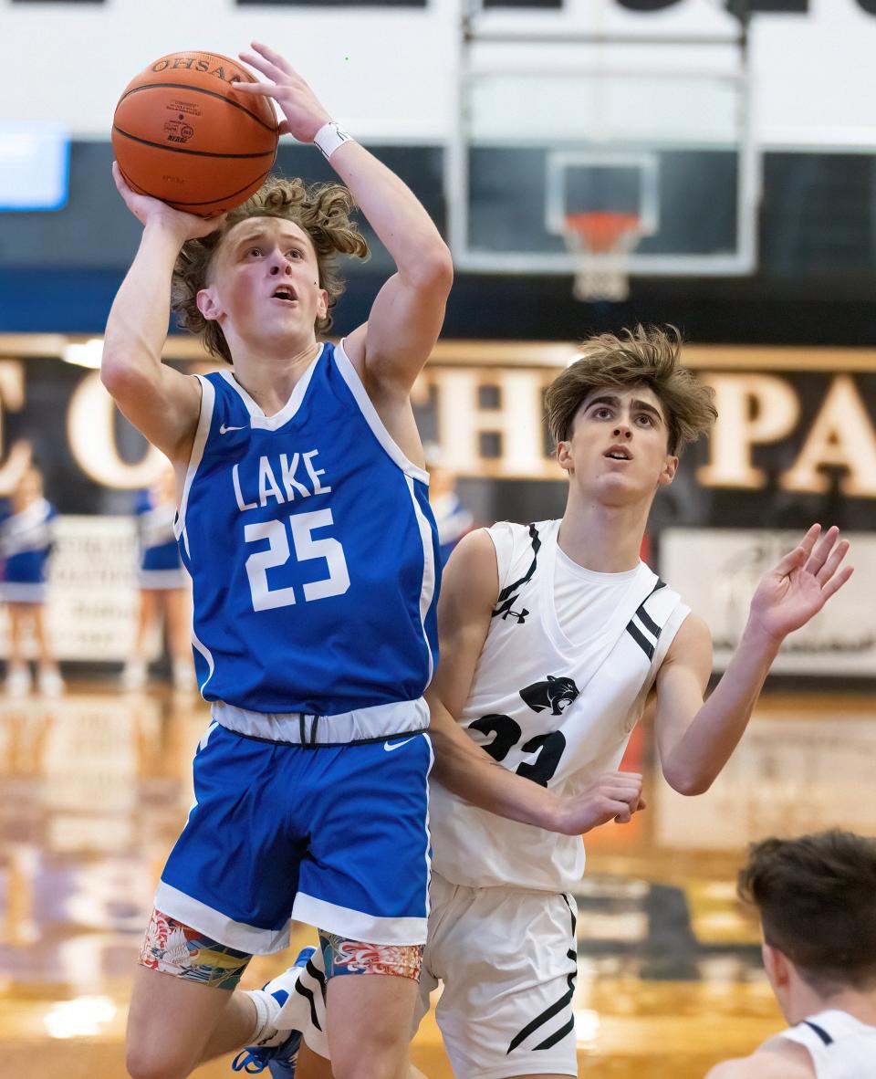 Lake’s Chance Casenhiser takes a shot in front Perry’s Luca Miller on Friday, Dec. 2, 2022.