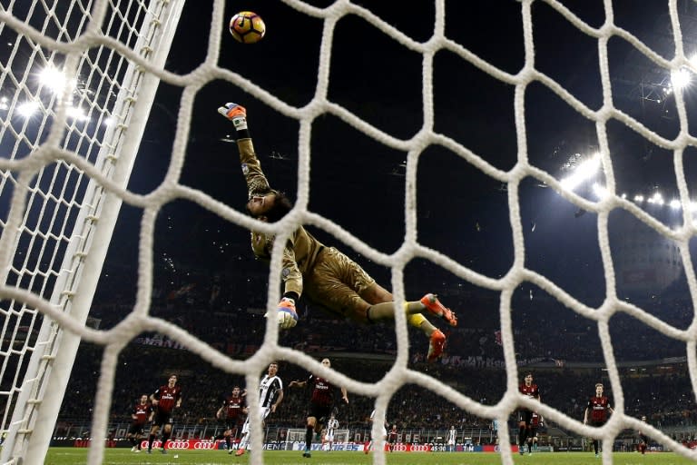 AC Milan's goalkeeper Gianluigi Donnarumma saves a goal during the match against Juventus on October 22, 2016 at the San Siro Stadium