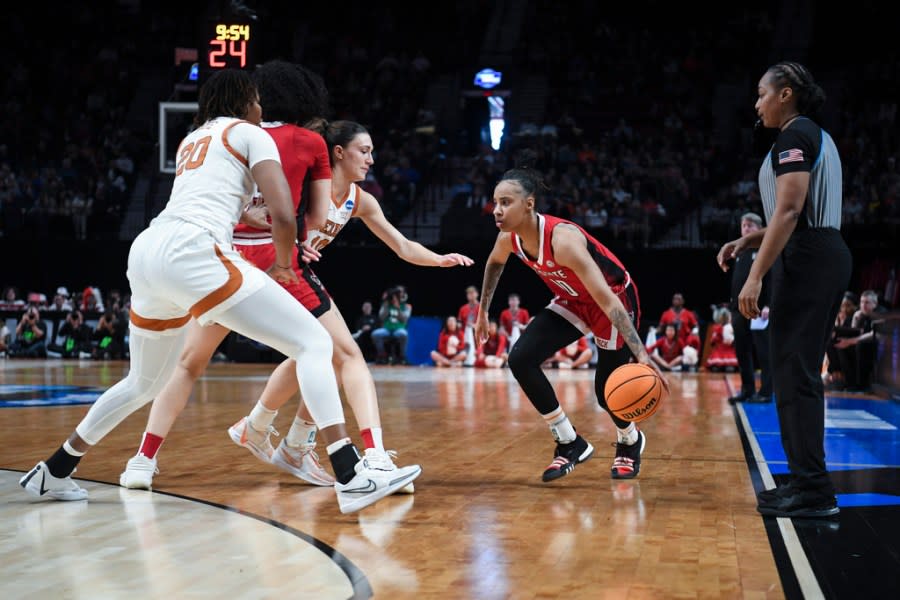 North Carolina State guard Aziaha James looks to get around the Texas defense during the first half of an Elite Eight college basketball game in the women’s NCAA Tournament, Sunday, March 31, 2024, in Portland, Ore. (AP Photo/Steve Dykes)
