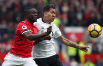 <p>Manchester United’s Eric Bailly (left) and Liverpool’s Roberto Firmino battle for the ball </p>