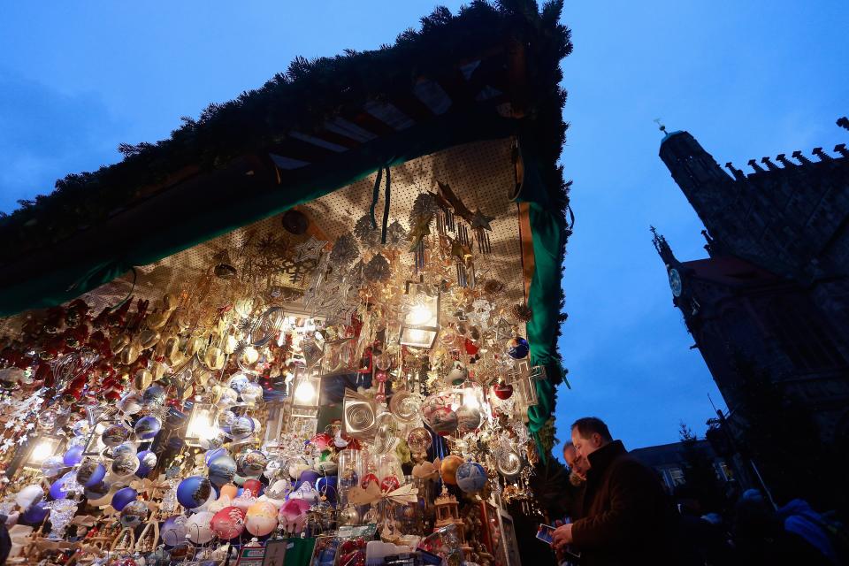 NUREMBERG, GERMANY - NOVEMBER 30: Visitors attend the traditional Christmas market 'Nuernberger Christkindlesmarkt' ahead of the opening ceremony on November 30, 2012 in Nuremberg, Germany. Originating in the 16th century the Nuremberg Christmas market is seen as one of the oldest of its kind in Germany. (Photo by Johannes Simon/Getty Images)