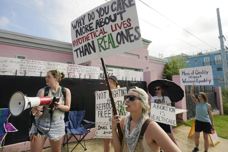 Abortion rights advocates stand outside the Jackson Women's Health Organization clinic in Jackson, Miss., and attempt to shout down a group of abortion opponents, Thursday, July 7, 2022. The clinic was the only facility that performed abortions in the state. However, on Tuesday, a chancery judge rejected a request by the clinic to temporarily block a state law banning most abortions. Without other developments in the Mississippi lawsuit, the clinic ceased abortions the end of business Wednesday and the state law took effect Thursday. The clinic saw a limited number of patients on Thursday, but not for abortions. (AP Photo/Rogelio V. Solis)