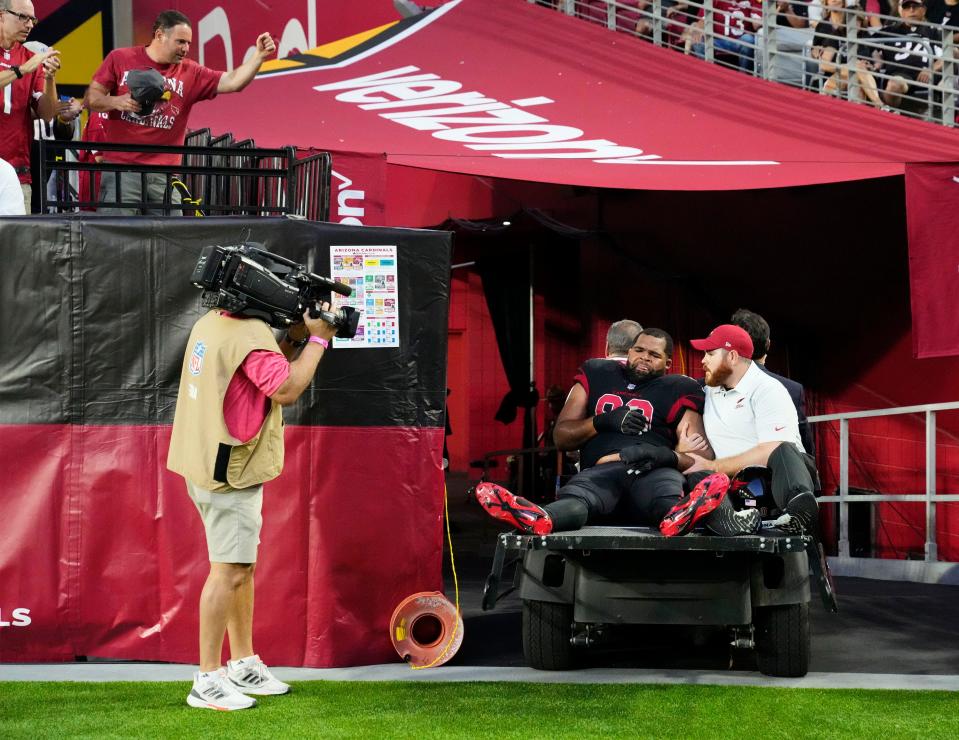 Arizona Cardinals defensive tackle Rashard Lawrence (90) leaves the game with an injury against the New Orleans Saints in the first half at State Farm Stadium.