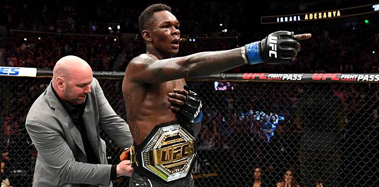 Dana White puts the belt on Israel Adesanya at UFC 236