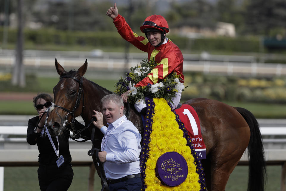 Wayne Lordan aboard Iridessa celebrates after winning the Breeders' Cup Filly and Mare Turf horse race at Santa Anita Park, Saturday, Nov. 2, 2019, in Arcadia, Calif. (AP Photo/Gregory Bull)