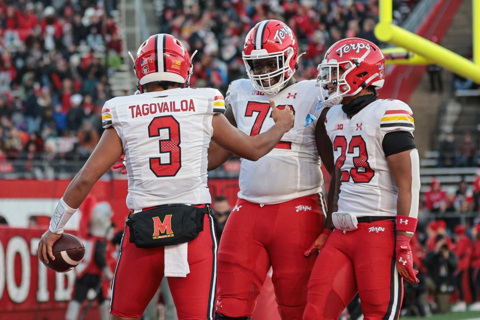 Nov 25, 2023; Piscataway, New Jersey, USA; Maryland Terrapins quarterback Taulia Tagovailoa (3) celebrates his rushing touchdown with offensive lineman Gottlieb Ayedze (72) and running back Colby McDonald (23) during the first half against the Rutgers Scarlet Knights at SHI Stadium. Mandatory Credit: Vincent Carchietta-USA TODAY Sports