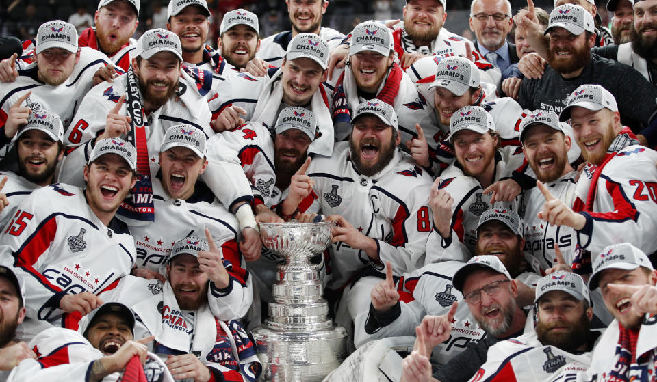 FILE - In this June 7, 2018, file photo, members of the Washington Capitals pose with the Stanley Cup after the Capitals defeated the Golden Knights 4-3 in Game 5 of the NHL hockey Stanley Cup Finals in Las Vegas. The ebb and flow of recent champions from fast and skilled to physical and punishing illustrates how many different blueprints there are to win a championship in today’s NHL and the importance of tailoring style of play to personnel and perfecting that chemistry. (AP Photo/John Locher, File)