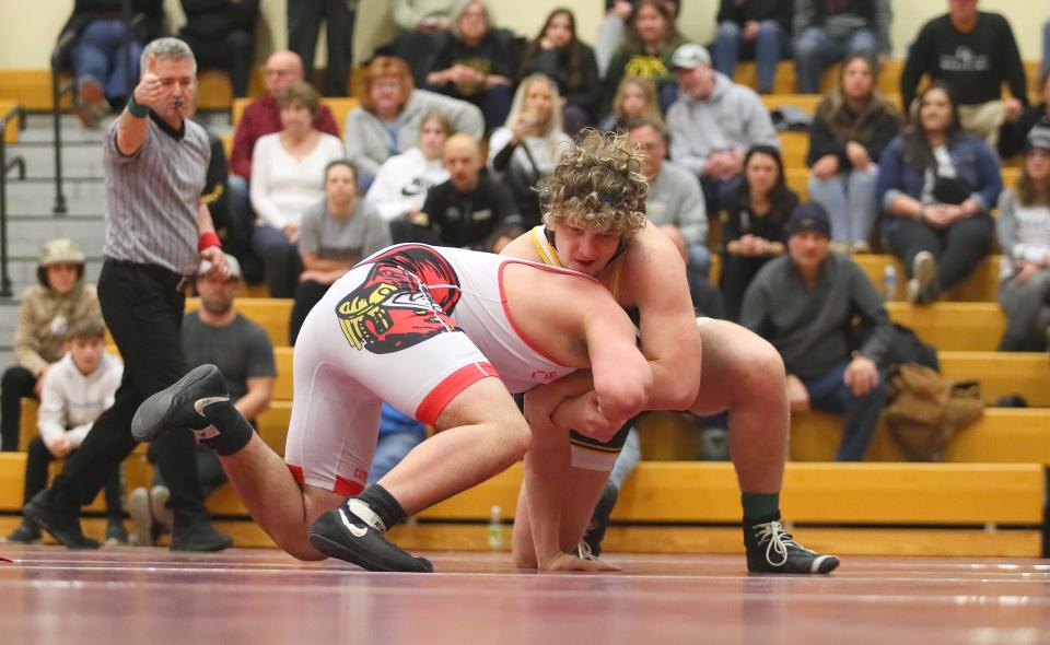 Quaker Valley's Chase Kretzler (black) grapples onto Frazier's Josh Girvin (red) during their 215 pound match while competing in the WPIAL 2A Wrestling Team Third Place Consolation match Saturday afternoon at Chartiers-Houston High School in Houston, PA.