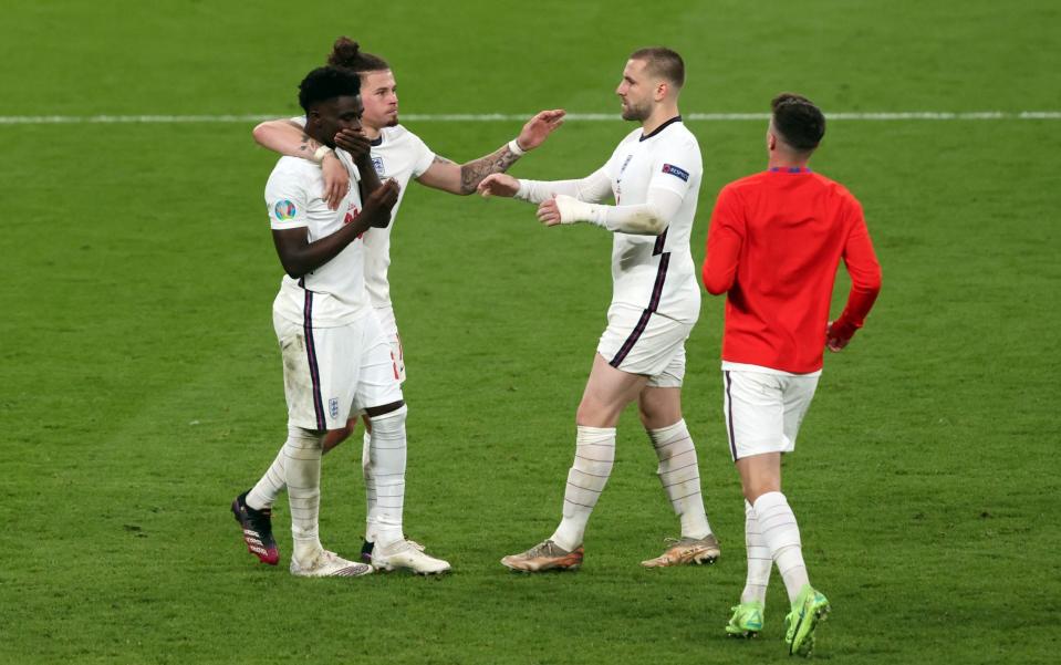 England players console Bukayo Saka after his penalty was saved - GETTY IMAGES