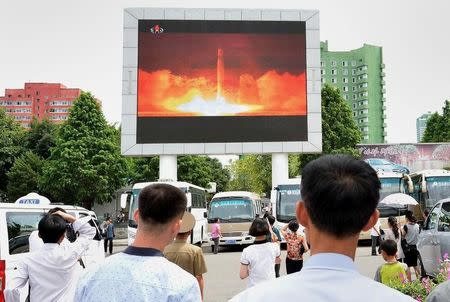 People watch news report showing North Korea's Hwasong-14 missile launch on electronic screen at Pyongyang station, North Korea in this photo taken by Kyodo on July 29, 2017. Mandatory credit Kyodo/via REUTERS/Files