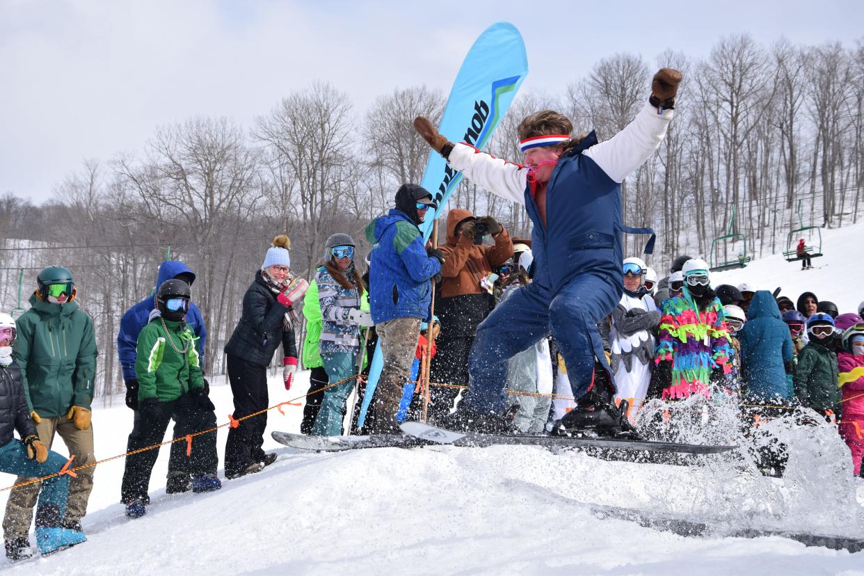 A skier jumps out of the end of "Lake Nubs" during the 2023 Mardi Gras event at Nub’s Nob.