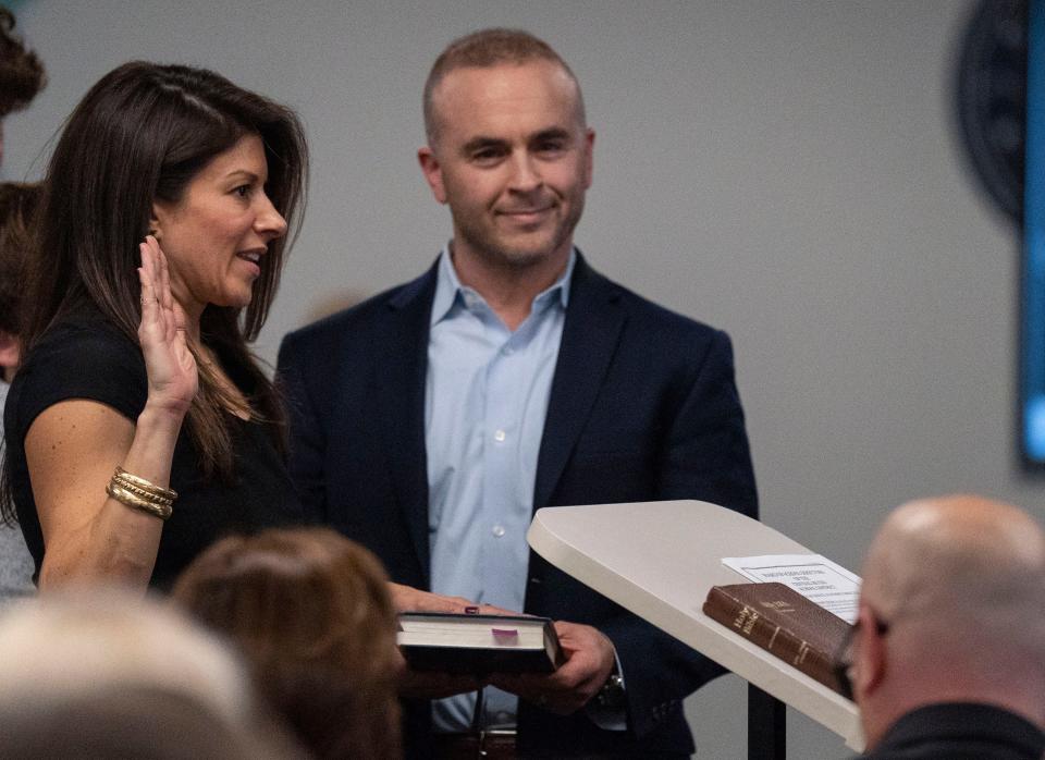 Newly-elected board member Heaher Reynolds, left, gets sworn-in with her husband, Gerard Reynolds, right, at her side at the Central Bucks School District Board re-org in Doylestown on Monday, Dec. 4, 2023. [Daniella Heminghaus | Bucks County Courier Times]