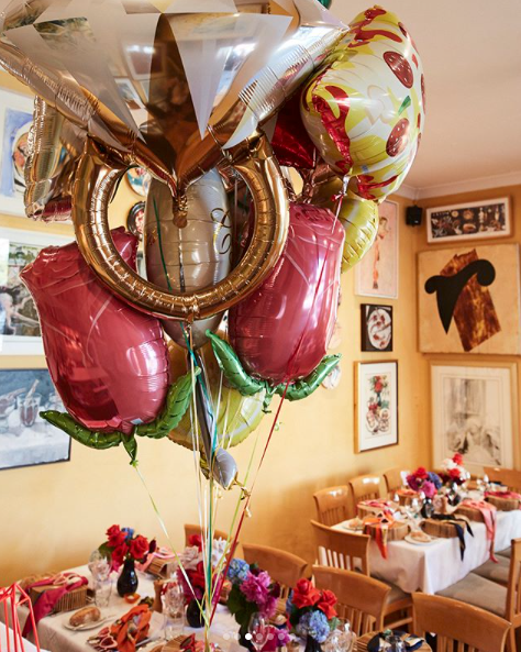 <p>The restaurant was filled with balloons and flowers.</p>