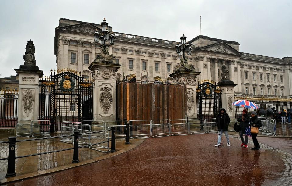 Buckingham Palace's gates are boarded up after someone crashed a car