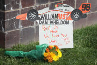 INDIANAPOLIS, IN - OCTOBER 17: Flower lay by the gate at the Indianapolis Motor Speedway along with other tributes left by fans to two-time Indianapolis 500 winner Dan Wheldon on October 17, 2011 in Indianapolis, Indiana. Wheldon, winner of the 2011 Indy 500, was killed in a crash yesterday at the Izod IndyCar series season finale at Las Vegas Motor Speedway. (Photo by Scott Olson/Getty Images)