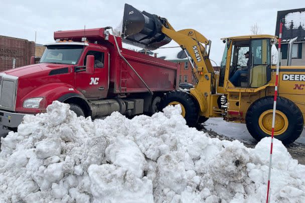 PHOTO: A front loader dumps snow into a dump truck along a residential street in Buffalo, N.Y. , on Dec. 29, 2022. (Carolyn Thompson/AP)