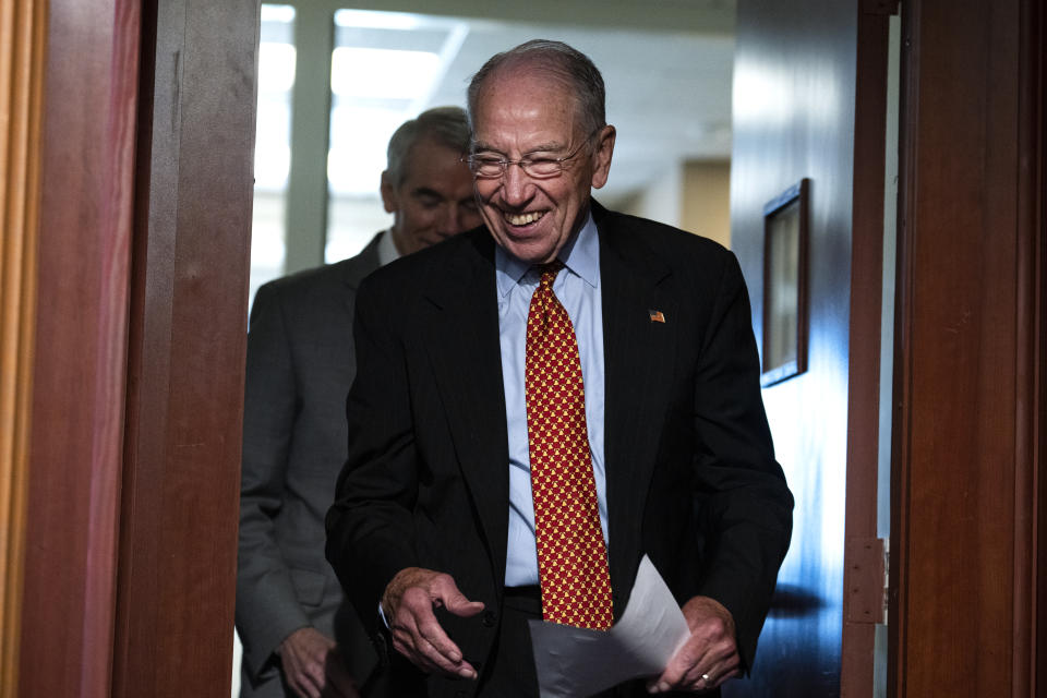 Sens. Chuck Grassley and Rob Portman walk into a room at the Capitol.