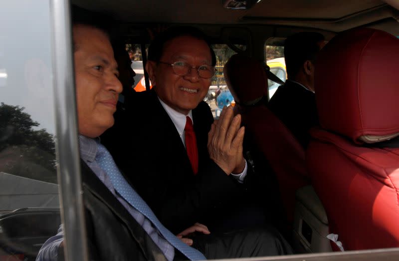 Cambodian opposition leader Kem Sokha greets as he leaves the Municipal Court of Phnom Penh