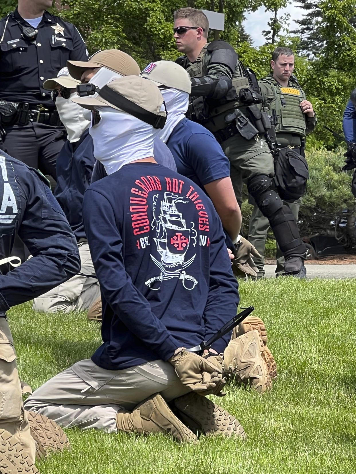 Authorities arrest members of the white supremacist group Patriot Front near an Idaho pride event Saturday, June 11, 2022, after they were found packed into the back of a U-Haul truck with riot gear. (Georji Brown via AP)