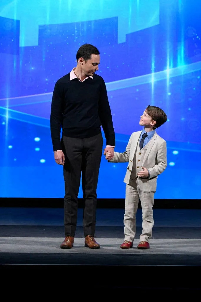 Jim Parsons and young Iain Armitage onstage holding hands