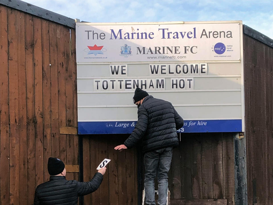 Volunteers hang up letters welcoming Tottenham Hotspur ahead of their FA Cup match (AP)