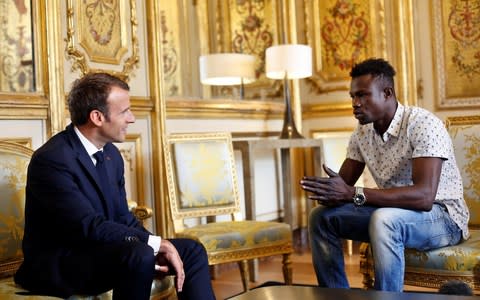 French President Emmanuel Macron meets with Mamoudou Gassama, 22, from Mali, at the Elysee Palace in Paris - Credit: POOL