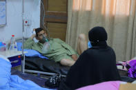 A coronavirus patient receives treatment at a hospital in Najaf, Iraq, Wednesday, July 14, 2021. Infections in Iraq have surged to record highs amid a third wave spurred by the more aggressive delta variant, and long-neglected hospitals suffering the effects of decades of war are overwhelmed with severely ill patients. (AP Photo/Anmar Khalil)