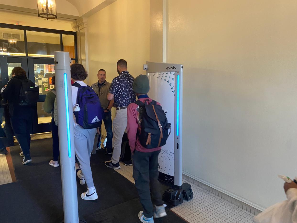 Hickman High School students on Wednesday file through a weapons detector that uses artificial intelligence to identify potential weapons. The system was demonstrated this week.