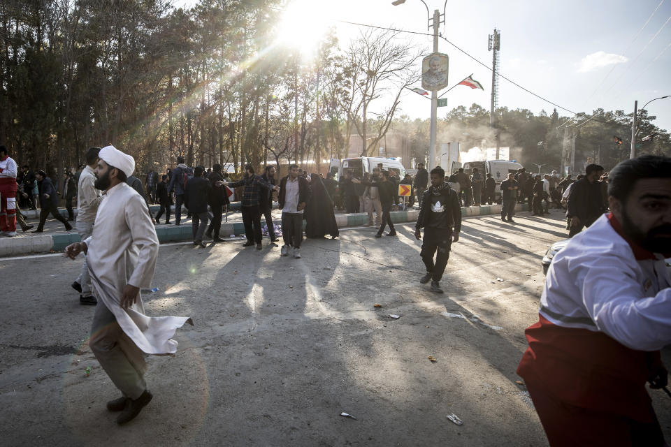 People are seen after an explosion in Kerman, Iran, Wednesday, Jan. 3, 2024. Explosions at an event honoring a prominent Iranian general slain in a U.S. airstrike in 2020 have killed at least 73 people and wounded over 170 others, state-run media in Iran reported Wednesday. (AP Photo/Mahdi Karbakhsh Ravari)