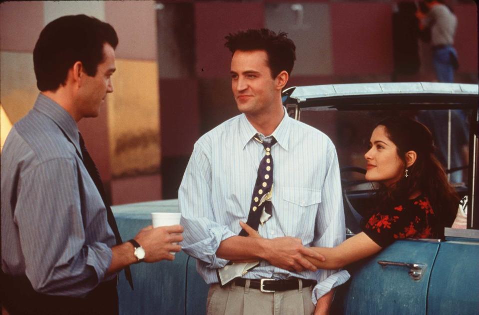 Jon Tenney looking at Matthew Perry and Salma Hayek as they hold each other in "Fools Rush In"