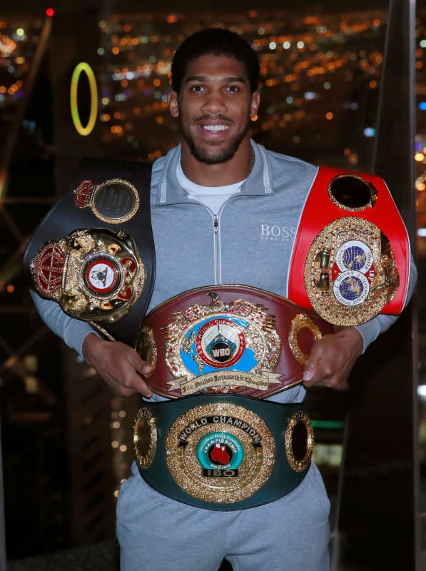 FILE PHOTO: Anthony Joshua poses with the IBF, WBA, WBO & IBO World Heavyweight belts after winning his title fight against Andy Ruiz Jr