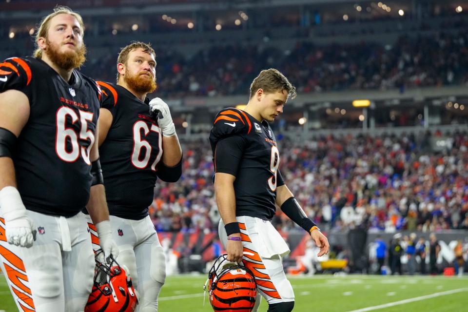 Cincinnati Bengals quarterback Joe Burrow (9) and both teams leave for the locker room as the game is suspended in the first quarter of the NFL Week 17 game between the Cincinnati Bengals and the Buffalo Bills at Paycor Stadium in Downtown Cincinnati on Monday, Jan. 2, 2023. The game was suspended with suspended in the first quarter after Buffalo Bills safety Damar Hamlin (3) was taken away in an ambulance following a play.